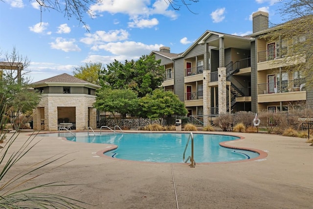 community pool with a patio area