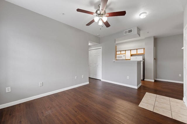 empty room with visible vents, baseboards, and wood finished floors