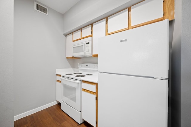 kitchen with visible vents, baseboards, light countertops, dark wood-style floors, and white appliances