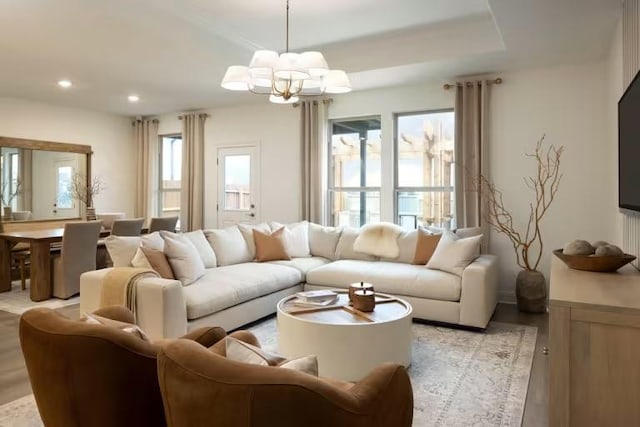 living room with an inviting chandelier, recessed lighting, and light wood-type flooring