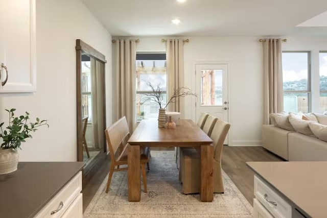 dining area featuring light wood-style floors and baseboards