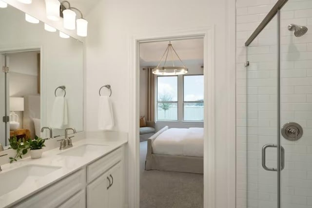 bathroom featuring a sink, a stall shower, and ensuite bathroom