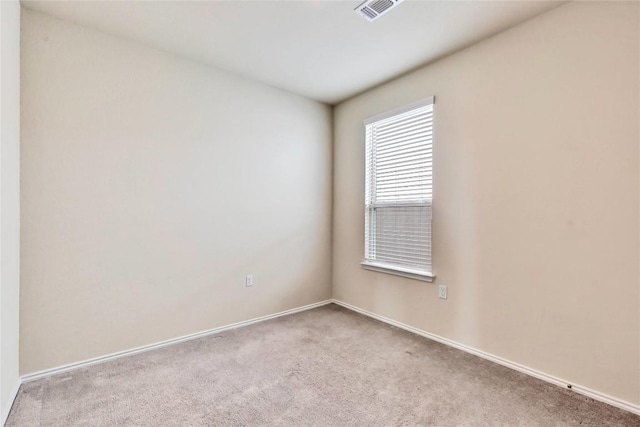 unfurnished room with visible vents, carpet flooring, and baseboards