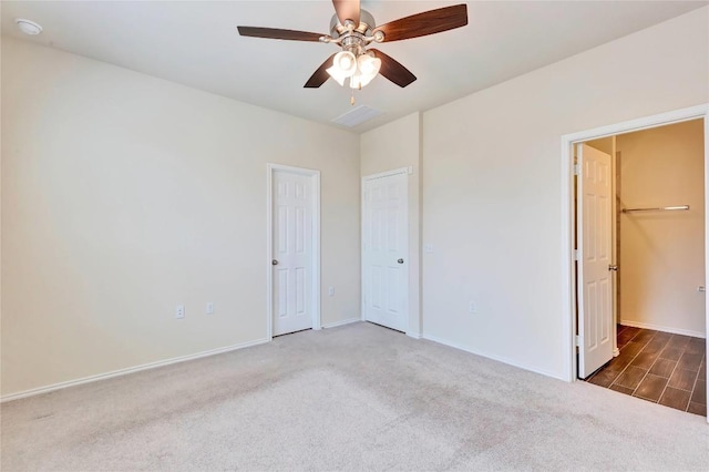 empty room featuring carpet flooring, a ceiling fan, and baseboards