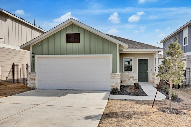 view of front of property with board and batten siding, a shingled roof, a garage, and concrete driveway