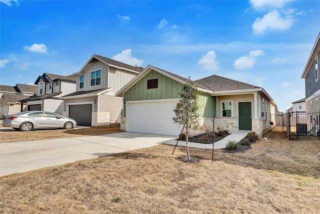 10309 American Paint Way, Manor, TX 78653 - view of front of property featuring board and batten siding, concrete driveway, stone siding, an attached garage, and roof with shingles
