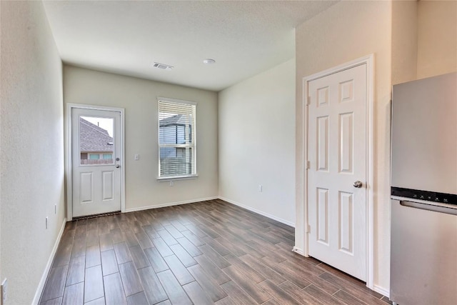 entrance foyer featuring visible vents, baseboards, and wood finish floors