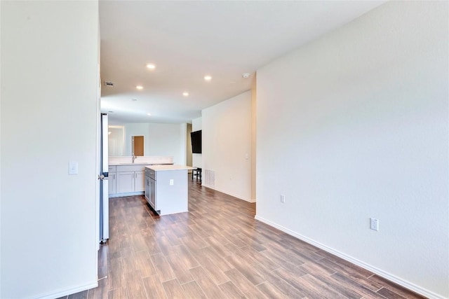 kitchen with visible vents, light countertops, recessed lighting, wood finished floors, and a sink