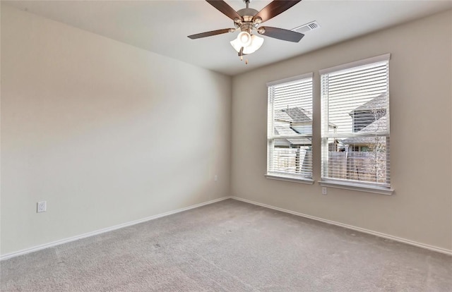 carpeted empty room featuring visible vents, baseboards, and a ceiling fan