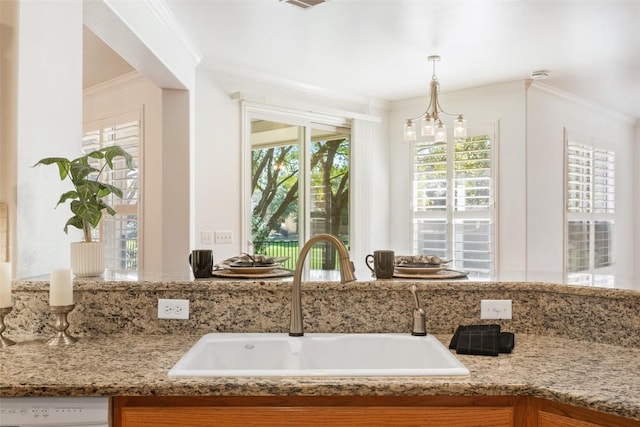 interior space featuring vanity, crown molding, and an inviting chandelier