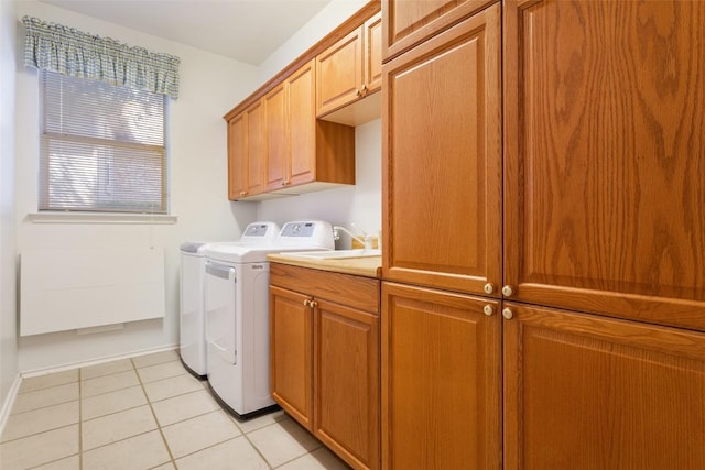 washroom with baseboards, cabinet space, independent washer and dryer, and light tile patterned flooring