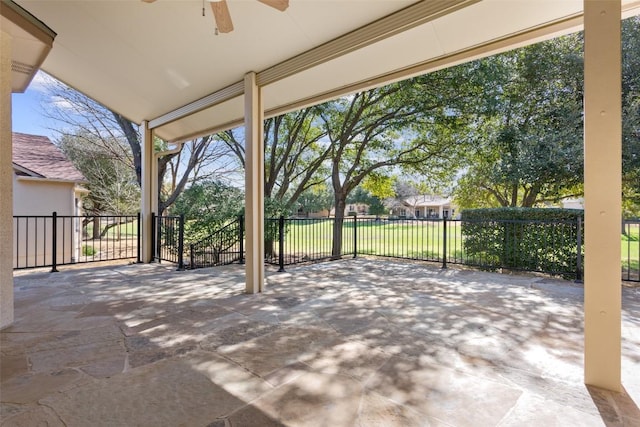 view of patio featuring a ceiling fan and fence