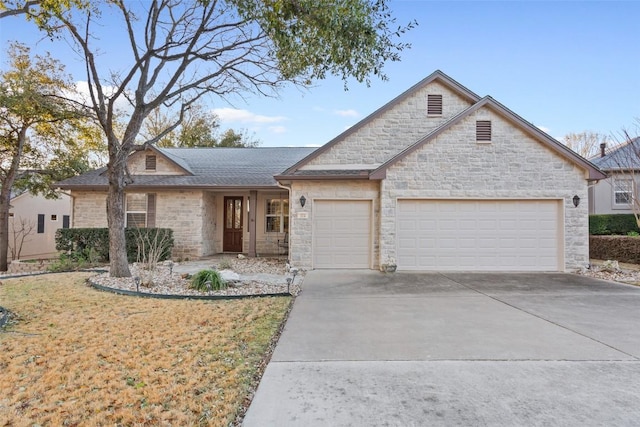 view of front of property with a front lawn, an attached garage, concrete driveway, and roof with shingles