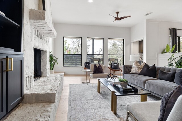 1209 Lost Creek Blvd, Austin, TX 78746 - living area featuring visible vents, a ceiling fan, wood finished floors, and a premium fireplace