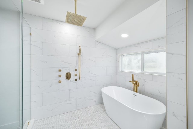 full bathroom with a soaking tub, tiled shower, and lofted ceiling