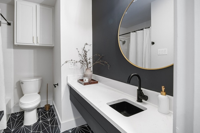 bathroom with vanity, a shower with shower curtain, baseboards, tile patterned flooring, and toilet