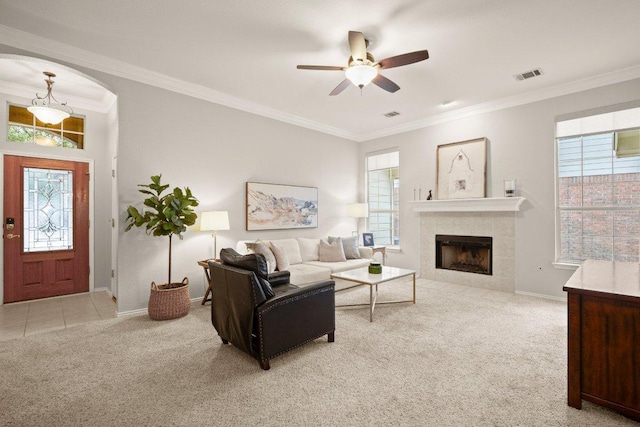 living room featuring visible vents, light carpet, a healthy amount of sunlight, and crown molding