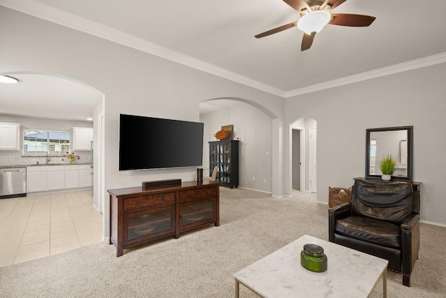 living area with ornamental molding, arched walkways, light tile patterned floors, and light carpet