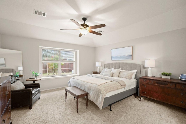 bedroom featuring visible vents, baseboards, light colored carpet, and ceiling fan