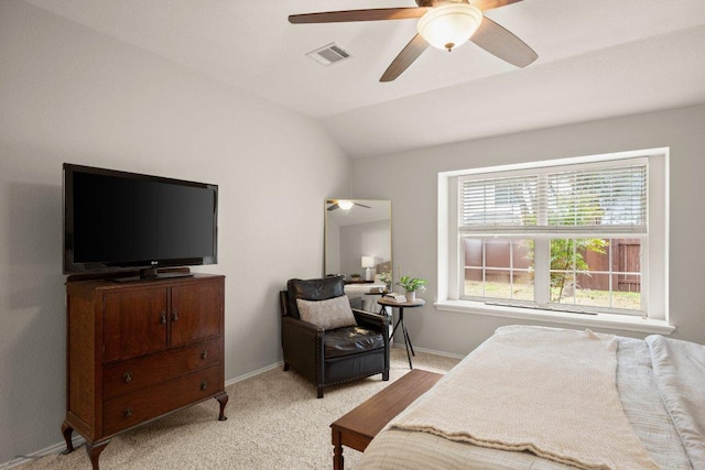 bedroom with baseboards, visible vents, light carpet, and lofted ceiling