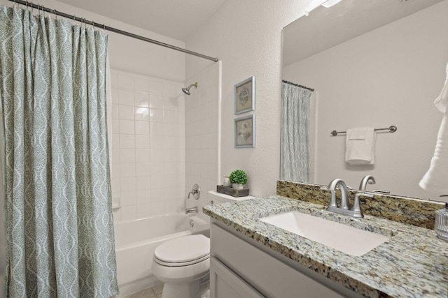 full bathroom with vanity, shower / tub combo, and toilet