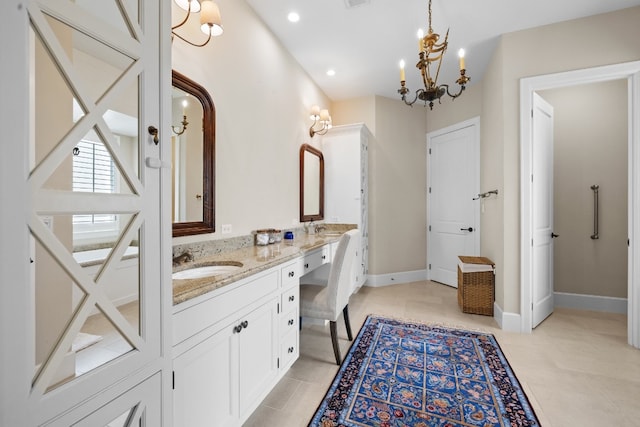 bathroom featuring baseboards, double vanity, recessed lighting, a sink, and a chandelier