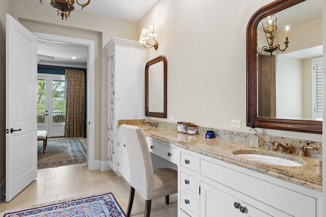 full bathroom featuring a sink, double vanity, and tile patterned floors