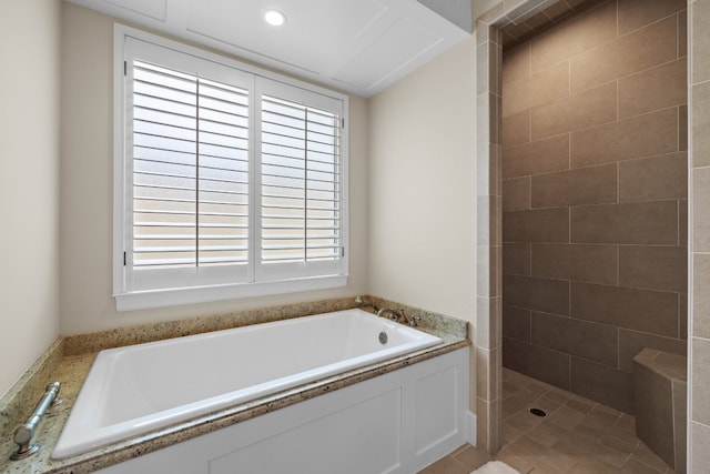 full bath with a garden tub and tiled shower