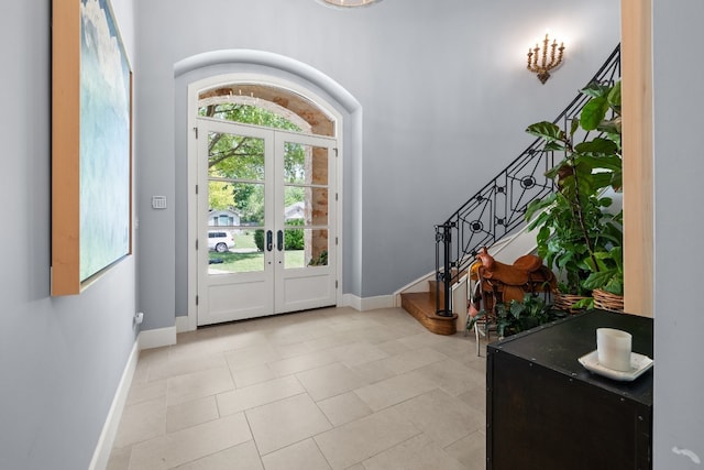 entryway with french doors, stairs, and baseboards