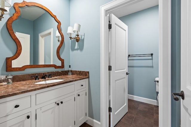 bathroom featuring tile patterned flooring, vanity, and baseboards