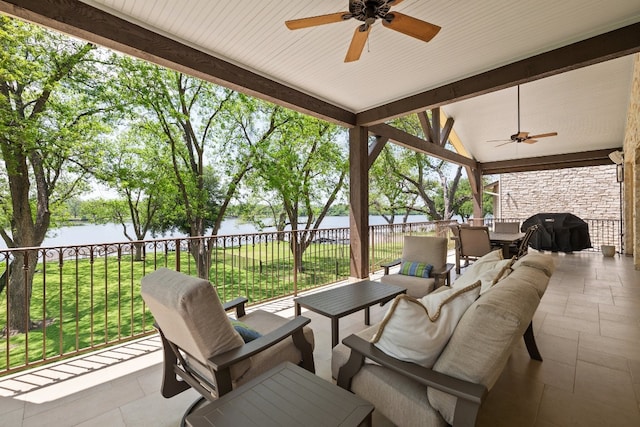 view of patio / terrace with grilling area, an outdoor living space, a water view, outdoor dining area, and a ceiling fan