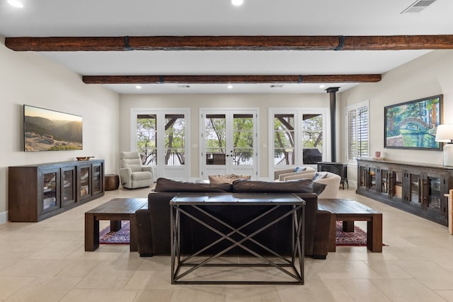 living room featuring recessed lighting, visible vents, beamed ceiling, and french doors