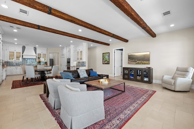 living area featuring beam ceiling, recessed lighting, baseboards, and visible vents