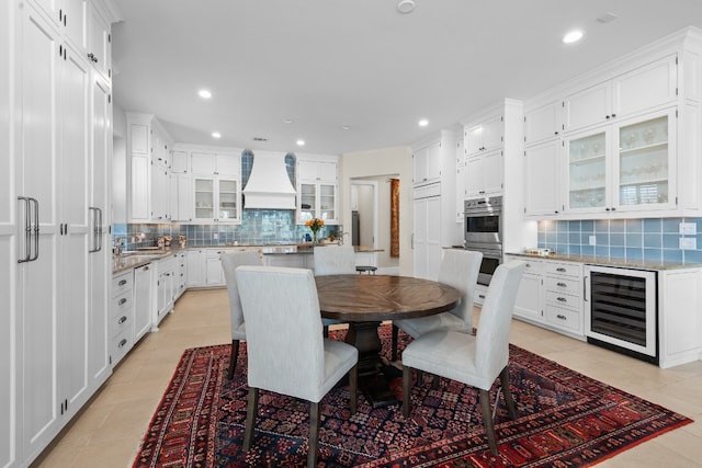 dining space featuring wine cooler, recessed lighting, and light tile patterned flooring