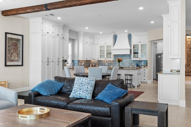 living area featuring visible vents, baseboards, beamed ceiling, recessed lighting, and light tile patterned flooring