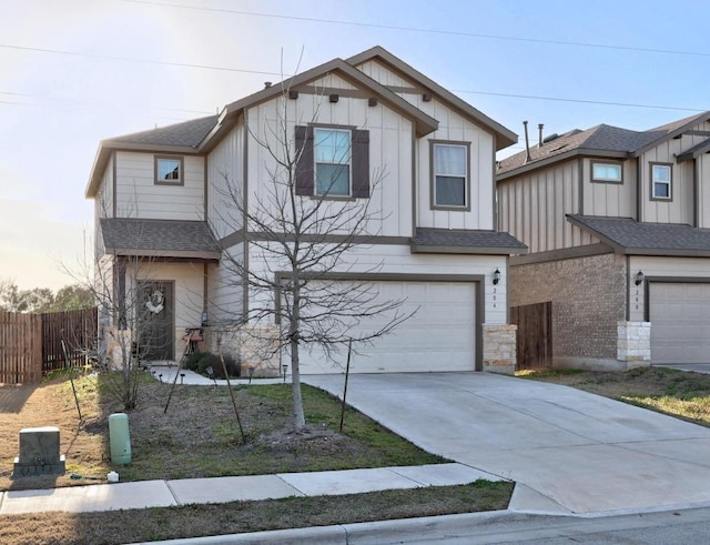 view of front of home featuring fence, roof with shingles, concrete driveway, a garage, and board and batten siding