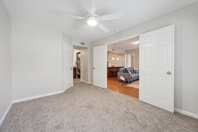 bedroom with ceiling fan, carpet floors, visible vents, and baseboards