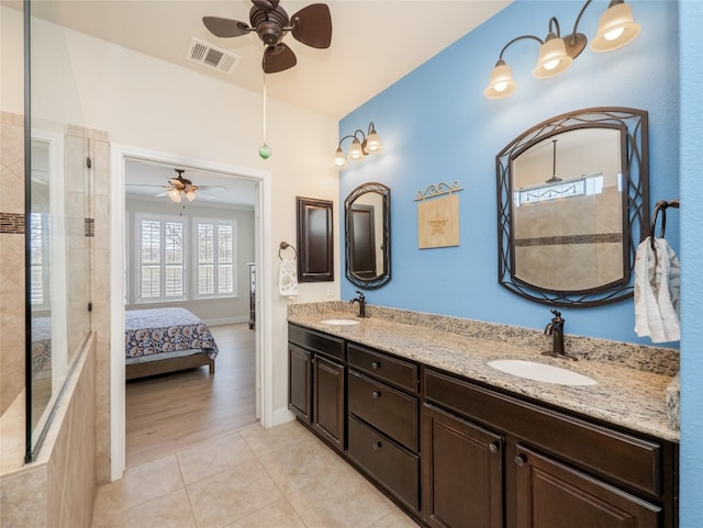 bathroom with tile patterned floors, double vanity, visible vents, and a sink