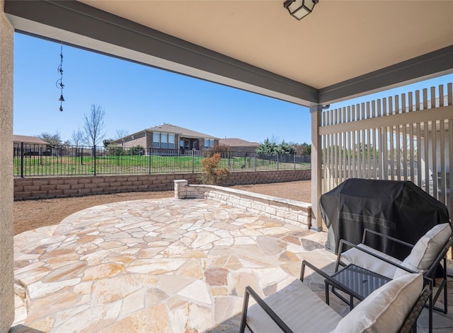 view of patio featuring fence and a residential view