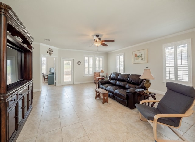 living area featuring crown molding, light tile patterned floors, and a wealth of natural light