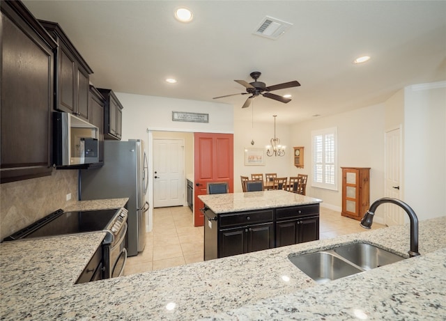 kitchen with visible vents, backsplash, light tile patterned floors, stainless steel appliances, and a sink