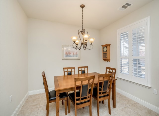 dining space with light tile patterned flooring, baseboards, visible vents, and a chandelier