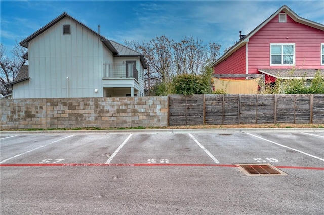 uncovered parking lot featuring fence