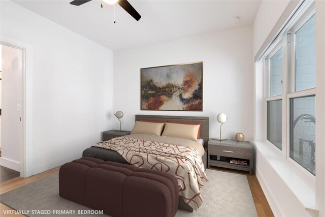 bedroom featuring wood finished floors, baseboards, and ceiling fan