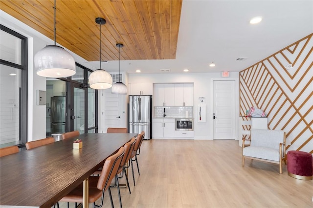 dining room with visible vents, recessed lighting, wooden ceiling, light wood finished floors, and stairs