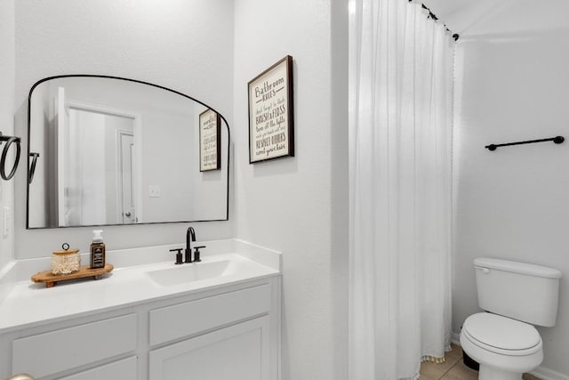 bathroom featuring tile patterned flooring, toilet, vanity, and a shower with shower curtain