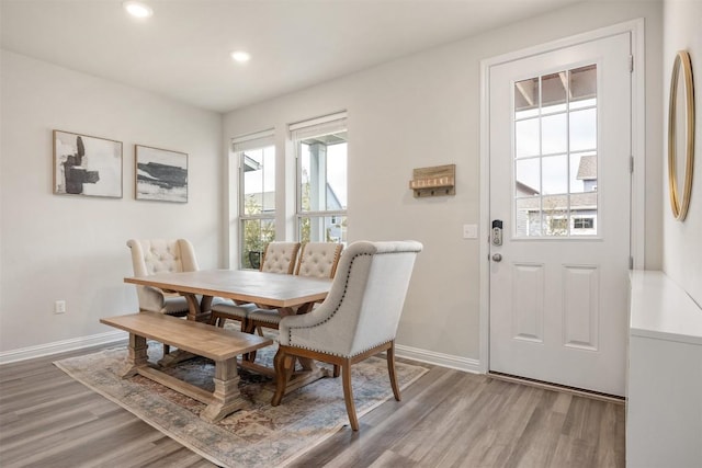 dining space with light wood-style flooring, recessed lighting, and baseboards