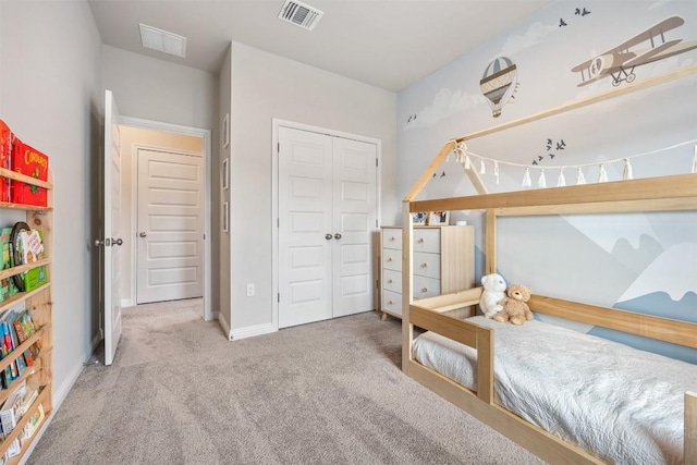 bedroom featuring a closet, visible vents, baseboards, and carpet