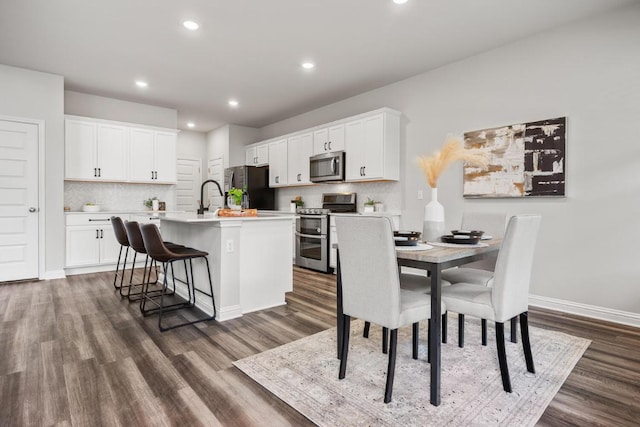 7902 Sutcliffe Dr, Austin, TX 78744 - dining space featuring dark wood-style floors, baseboards, and recessed lighting