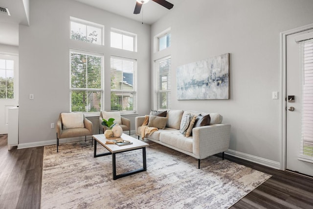 7902 Sutcliffe Dr, Austin, TX 78744 - living area featuring ceiling fan, wood finished floors, baseboards, and a high ceiling